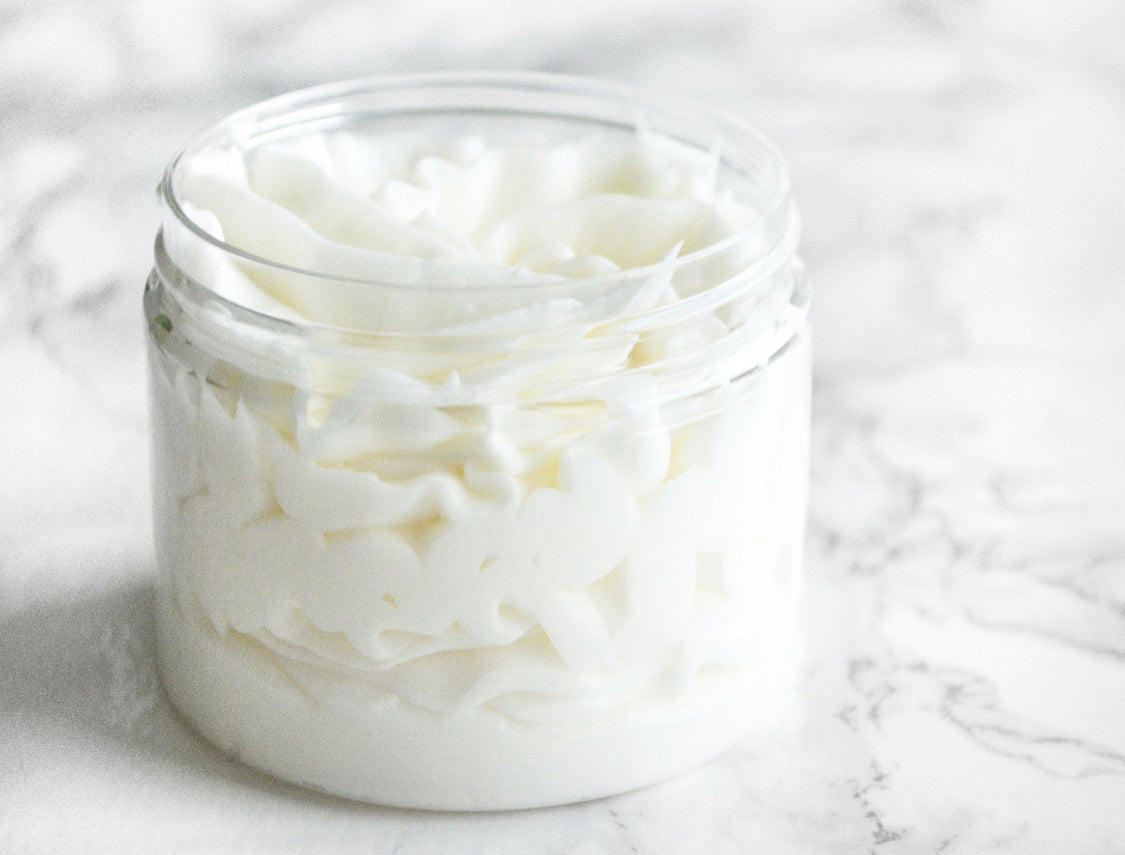 Vanilla Sandalwood Whipped Body Butter in a jar, showcasing its creamy texture and luxurious formulation. Enriched with nourishing ingredients for deep hydration and a soothing vanilla and sandalwood scent.
